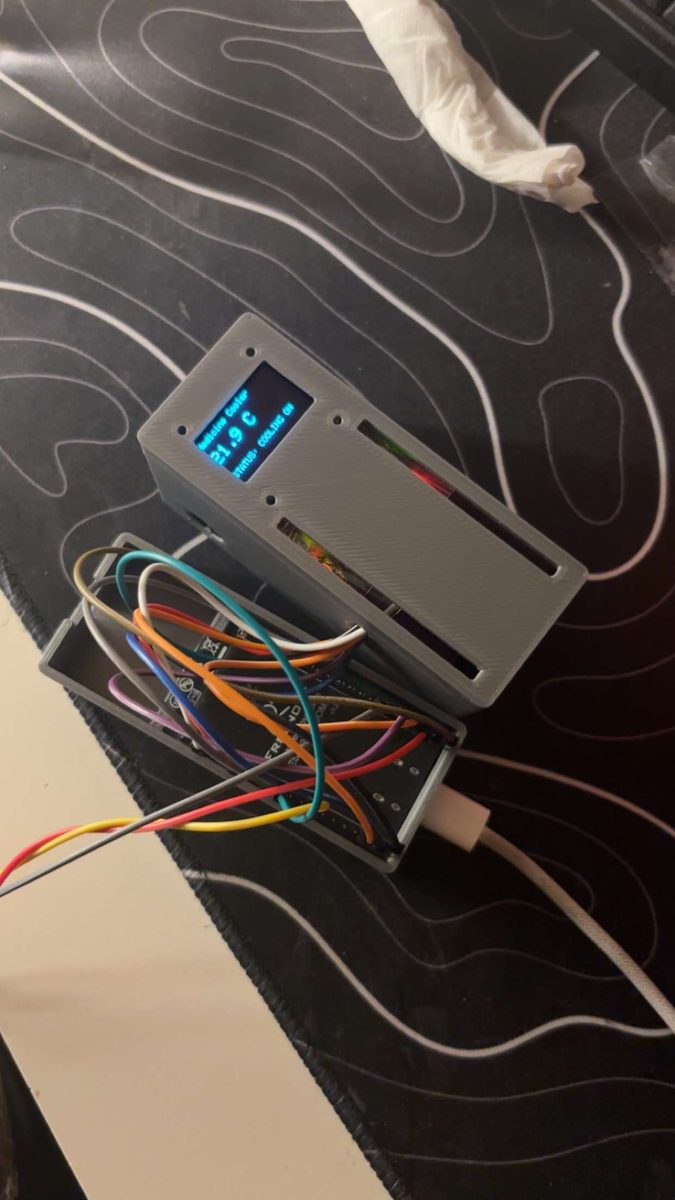 The 3D-printed control unit powered on, its OLED reading “Medicine Cooler — 21.9 C — STATUS: COOLING ON”, with the ESP32 and wiring in the open printed enclosure.